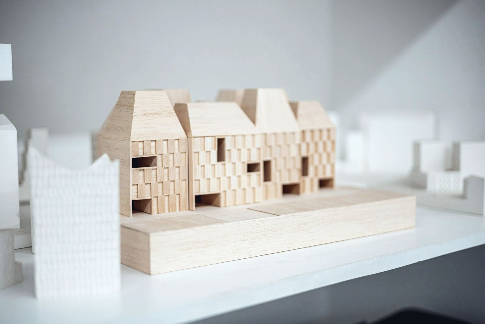A pale timber architectural model of a terrace of houses