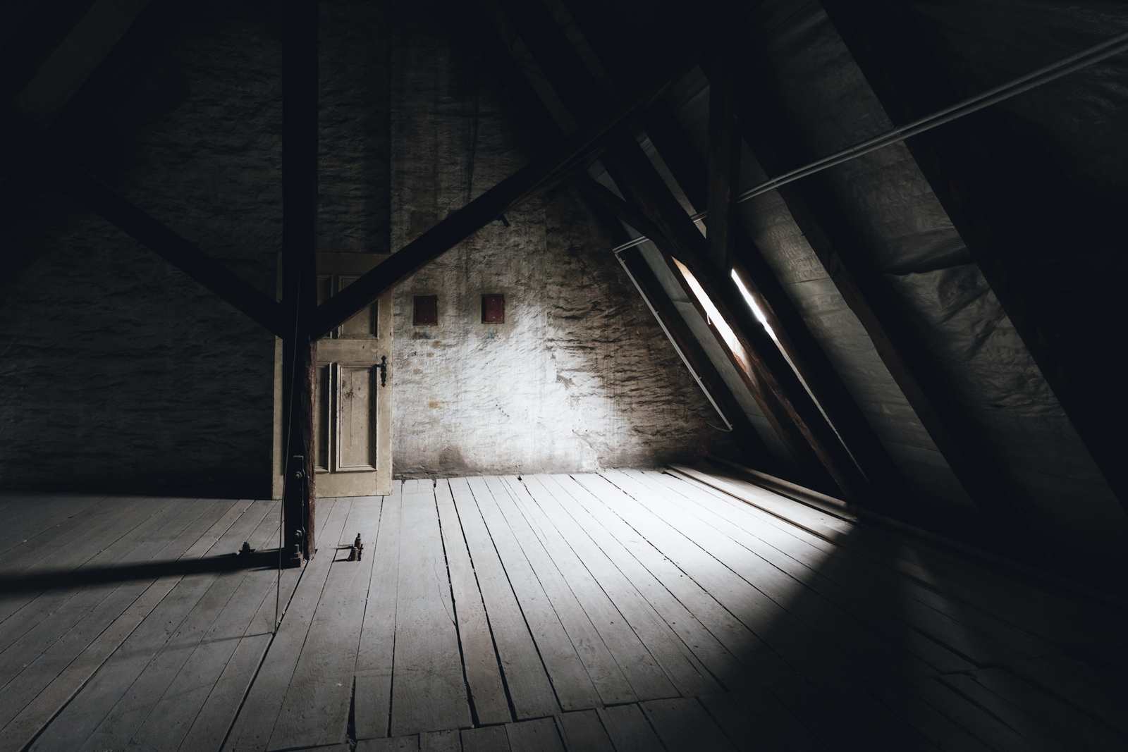 Before: the empty loft with bare boards and timber rafters