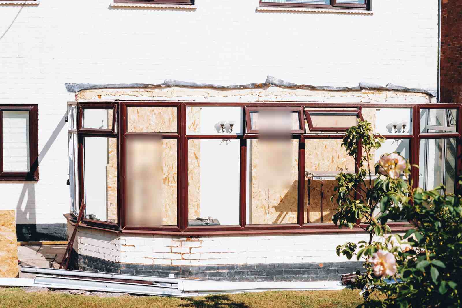 Before: the old uPVC conservatory being stripped out, with boarded frames