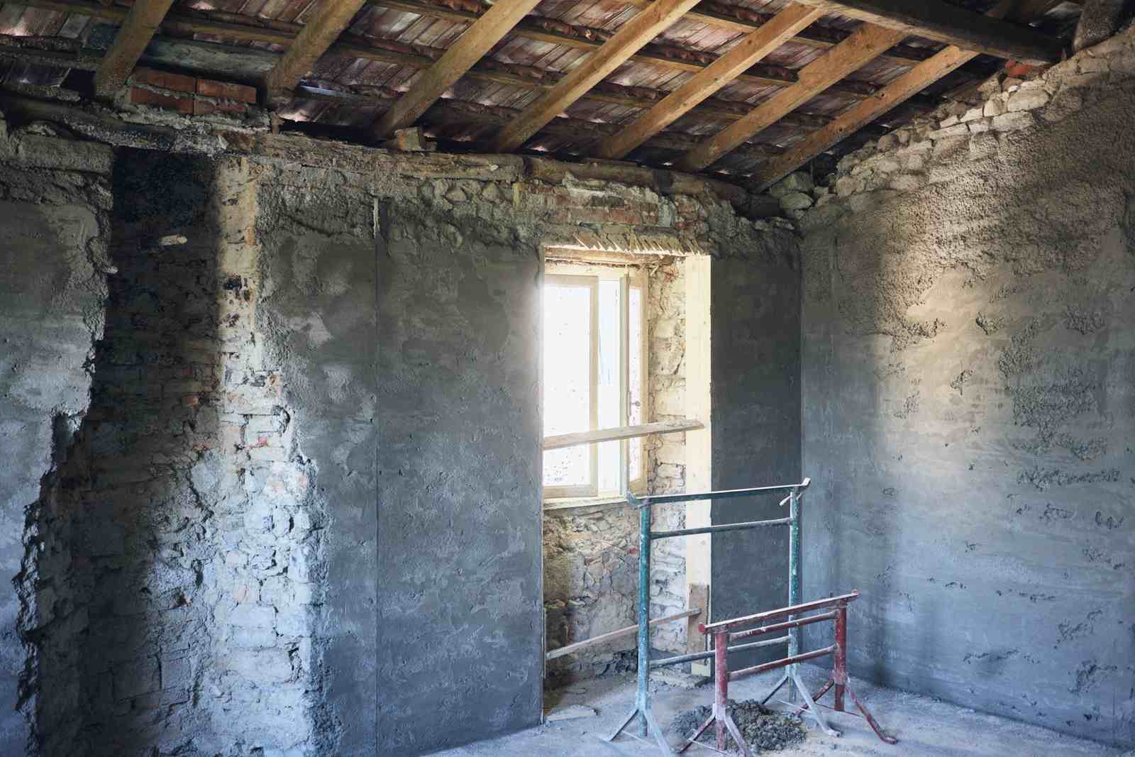 Before: the original cellar with rough stone walls and a single window