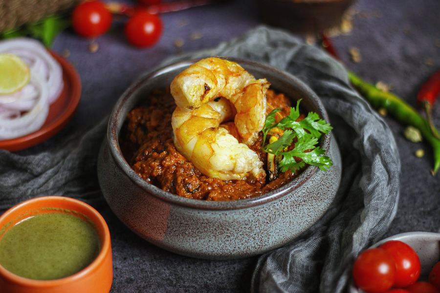 King prawn masala in a steel bowl
