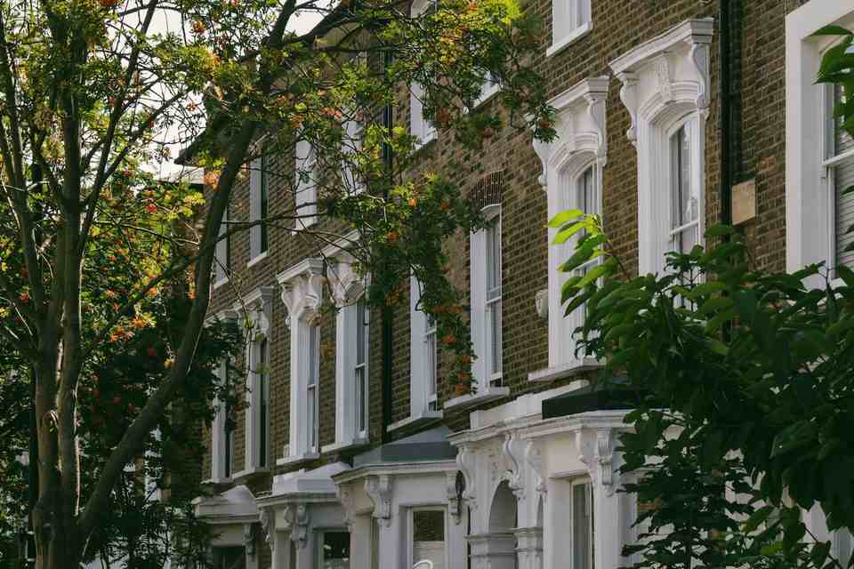 Phillimore Place, brick and stucco villas behind trees in Kensington