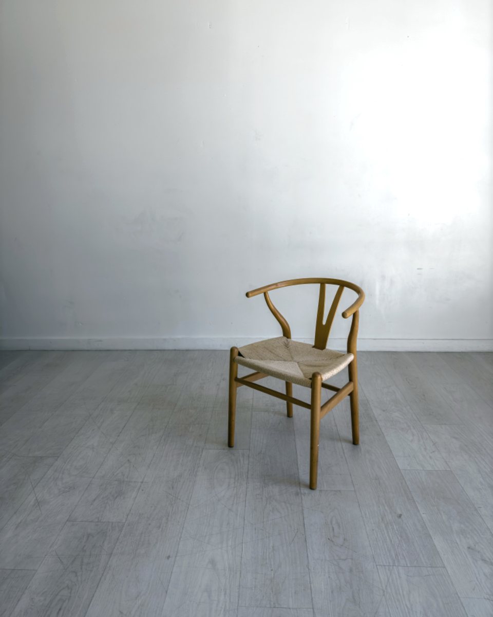 An empty, freshly cleaned room with a single wooden chair