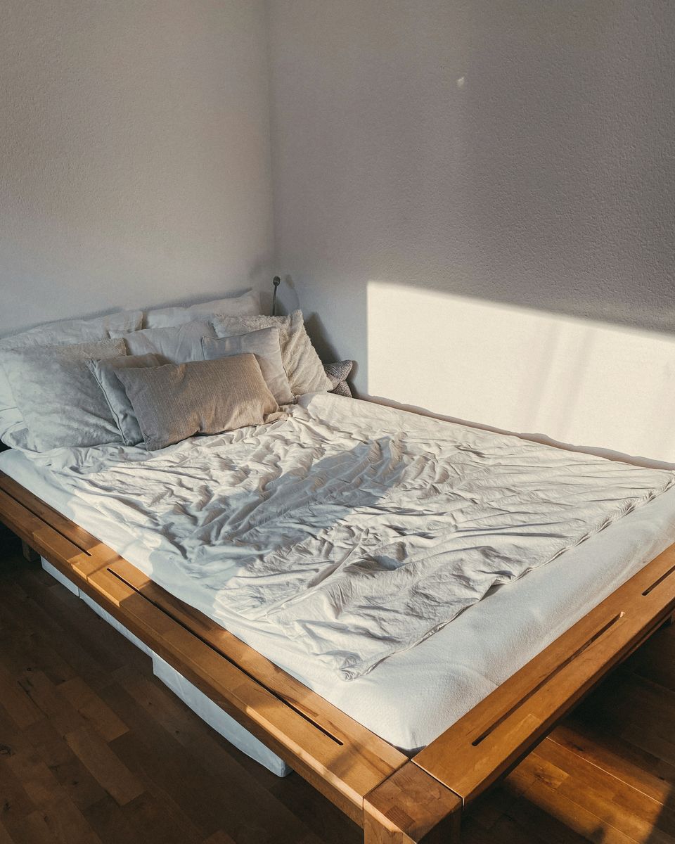 A made bed in soft morning light