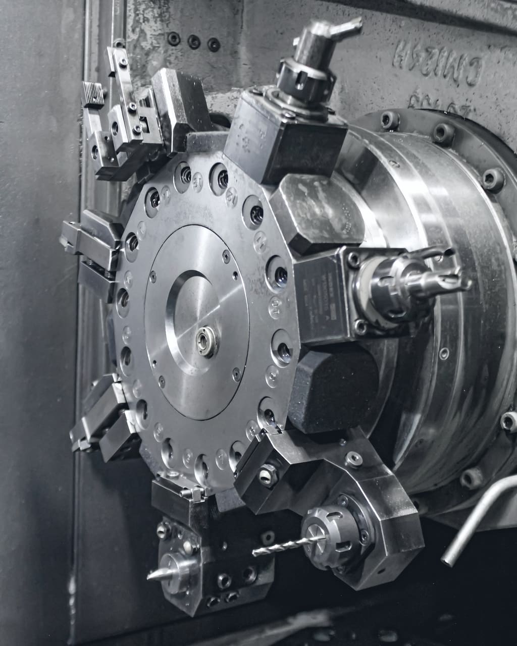 The turret and tool holders of a CNC lathe in close-up
