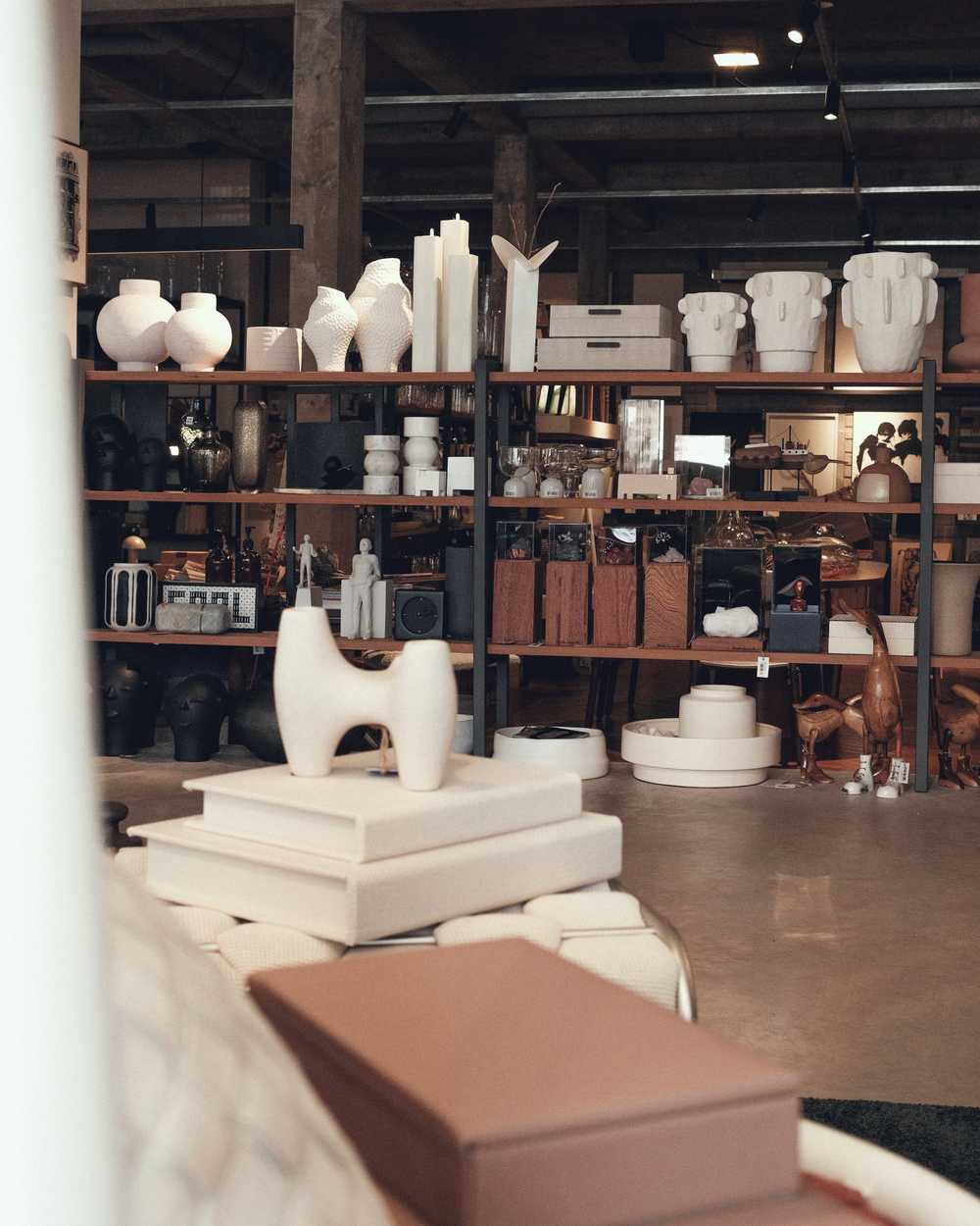 Shelves of white ceramics and wooden objects in the shop