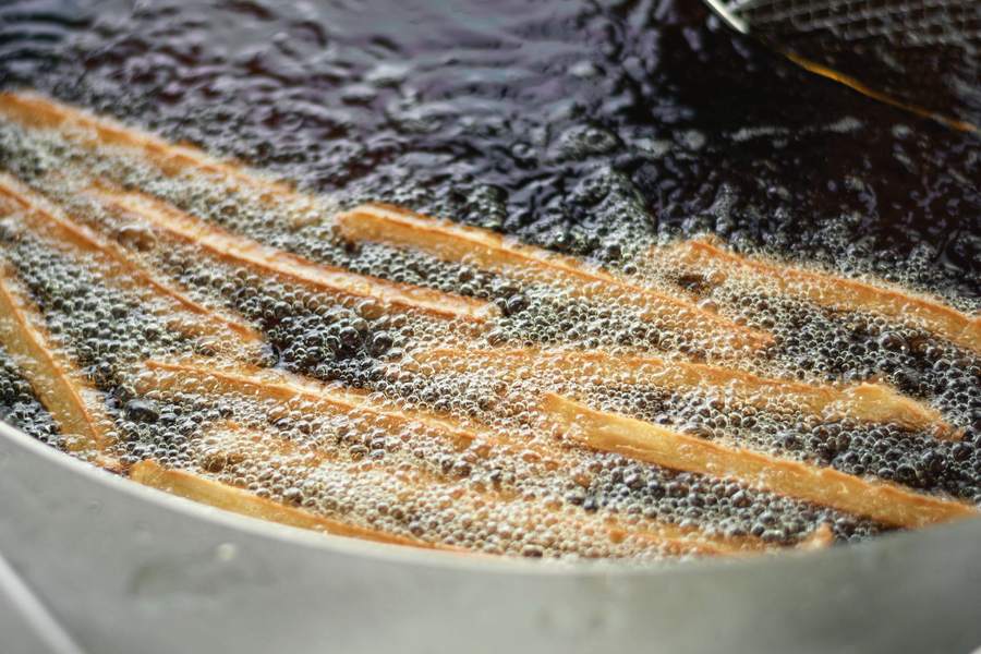 Chips bubbling in a fryer