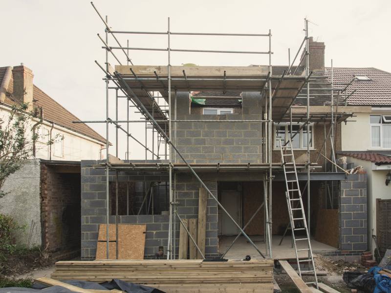 Scaffold around a part-built extension at the back of a semi-detached house