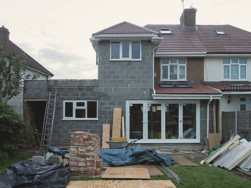 Nearly finished extension with blockwork, new glazed doors and the garden being cleared